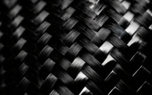 Hero image: glossy 2x2 twill carbon fiber weave close-up