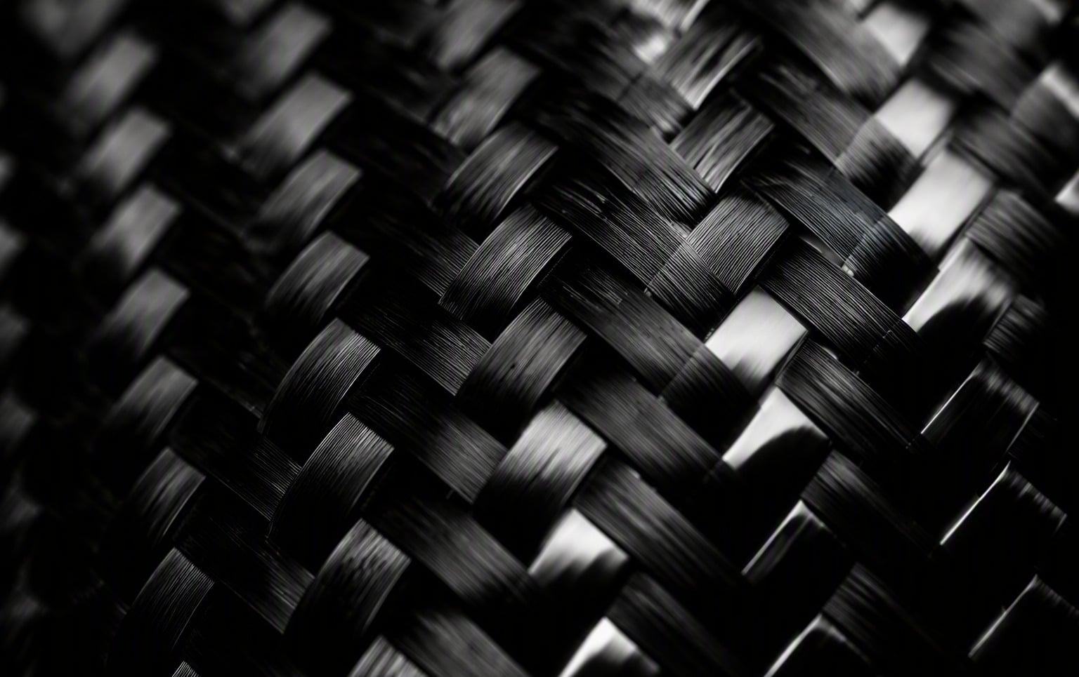 Hero image: glossy 2x2 twill carbon fiber weave close-up