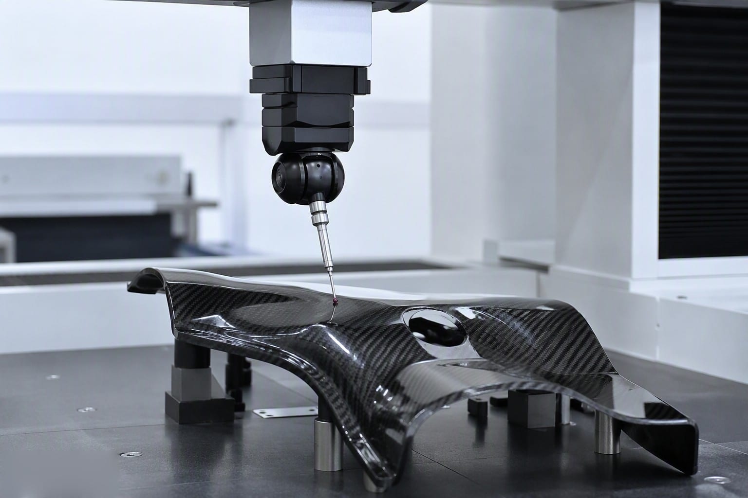 CMM inspection tools measuring a carbon fiber part for dimensional accuracy