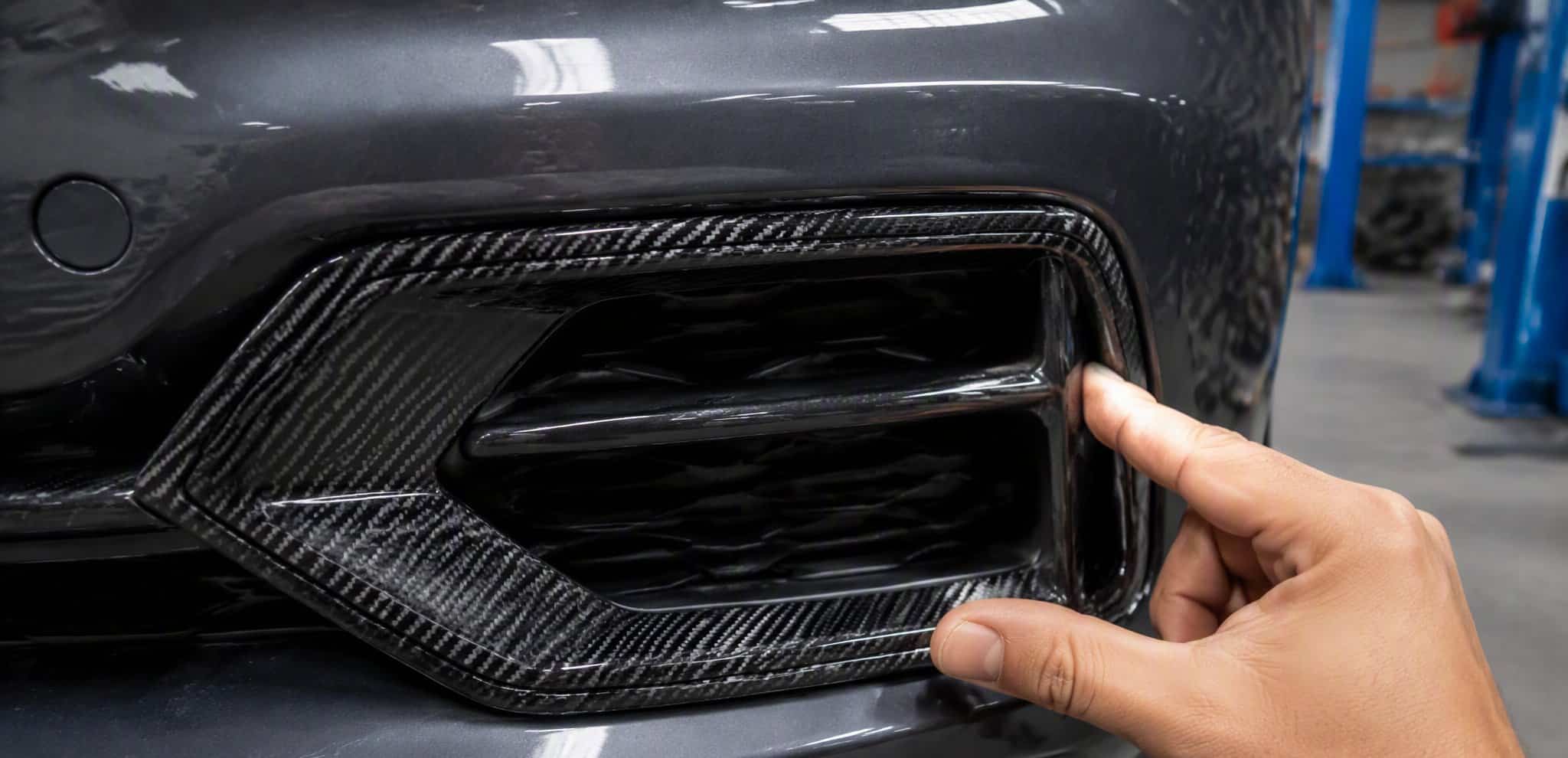 Pressing a carbon fiber vent trim into the bumper air intake
