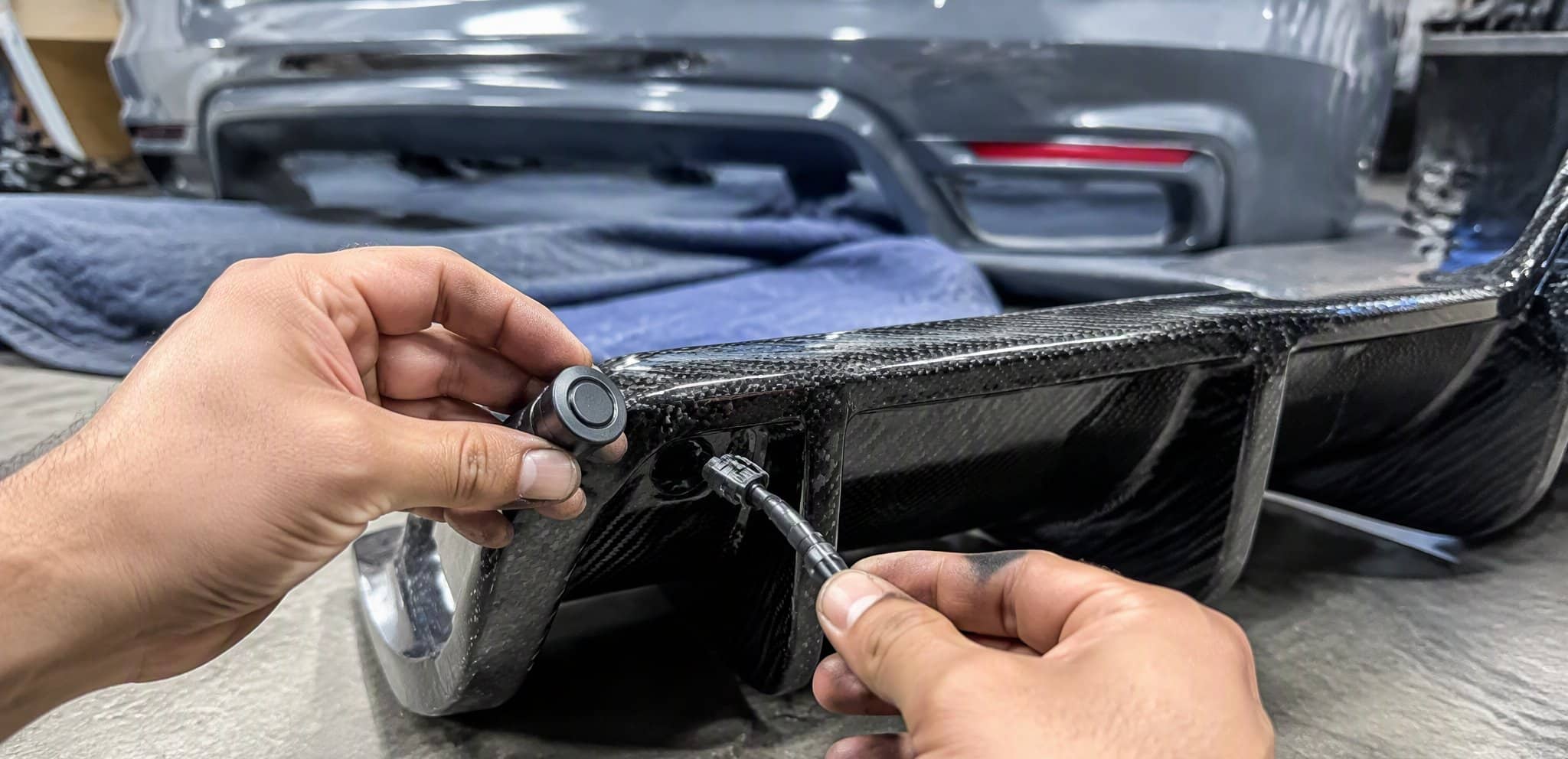 Transferring a parking sensor to a carbon fiber rear diffuser