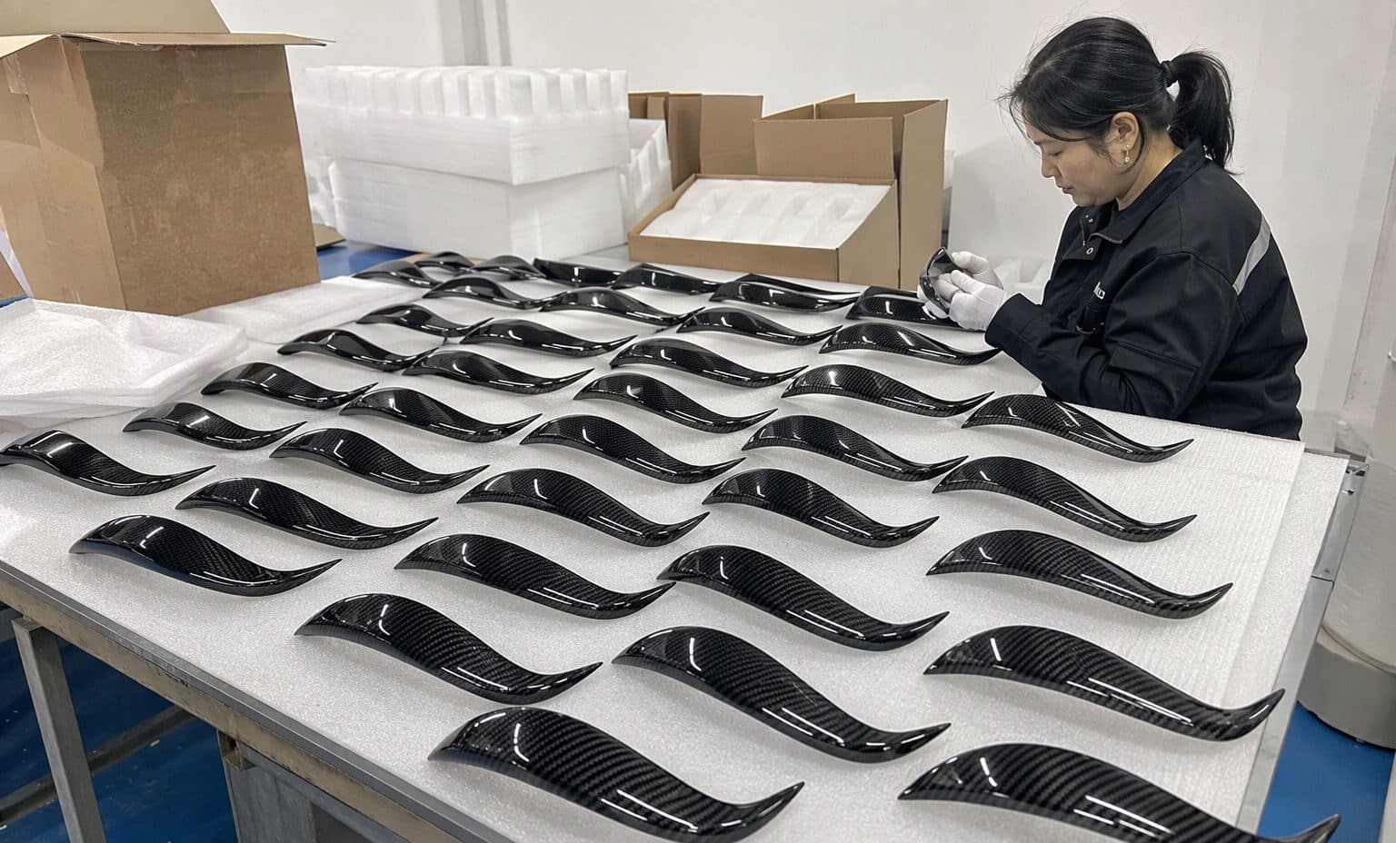 Inspection on carbon fiber headlight eyelids at the JC AUTOCARBON factory