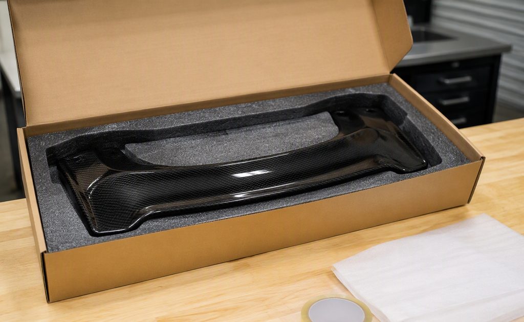 Replacement carbon fiber part packed in a foam-lined box